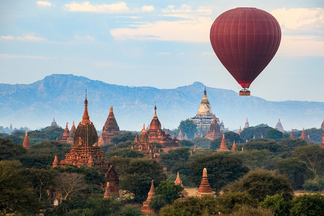 Hot air balloon over plain of Bagan in misty morning, Myanmar
